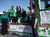 Ray Marneris, CFO of Smith Senior Living (left) and Kevin McGee, President and CEO of Smith Senior Living (right) cheer on the Residents of Note musical group at the parade.