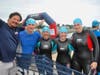 Rob, Julie and Elizabeth Colligan (center) at a Swim Across America Fairfield County open water swim event. Pictured with them is Olympic swimmer Craig Beardsley (left) and a friend. The Colligan family are participating in the open water swim on June 24.