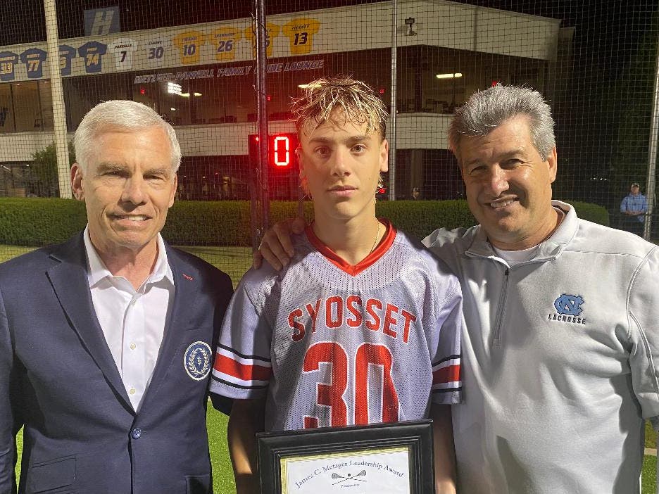 Josh Weisenfeld of Syosset High School received the 2026 James C. Metzger Lacrosse Leadership Award from Long Island lacrosse stars James C. Metzger, left, and Vincent J. Sombrotto. 