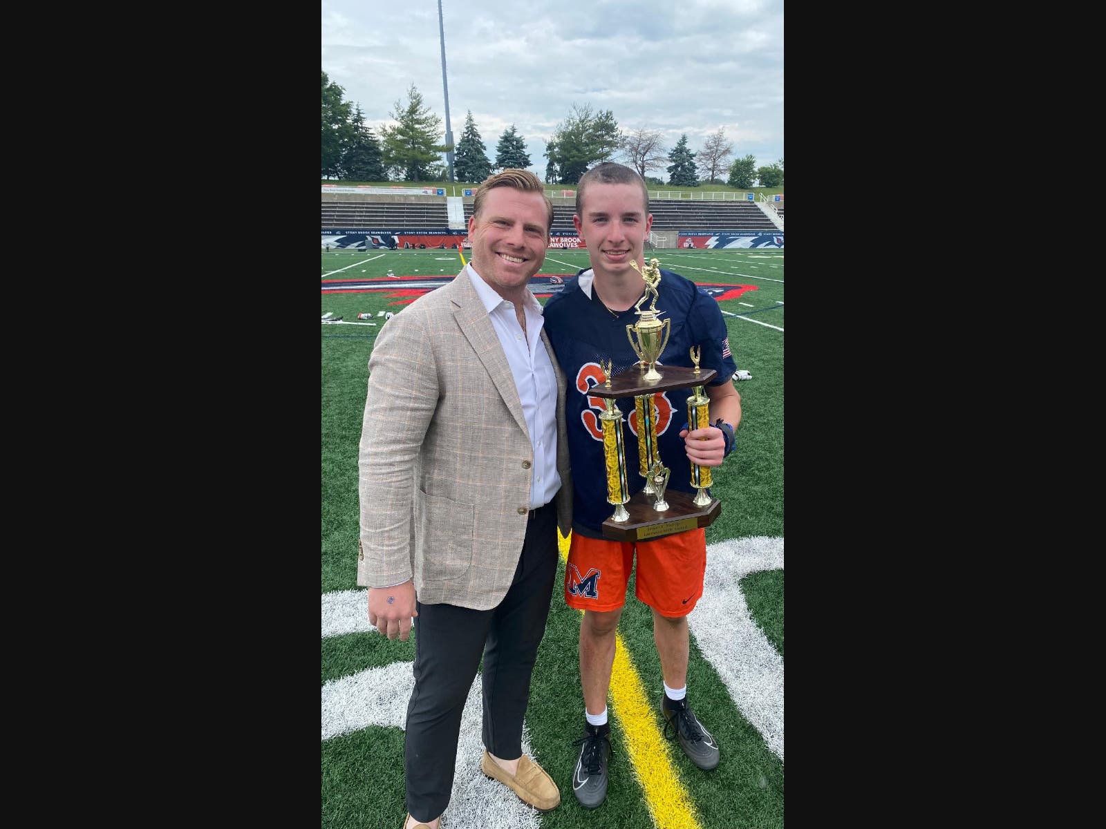 Freshman goalie Andrew Limberg of Manhasset High School received the James C. Metzger MVP Award from Long Island lacrosse all-star and All-American James Pannell at the Class B 2026 Long Island Boys Lacrosse Championships.