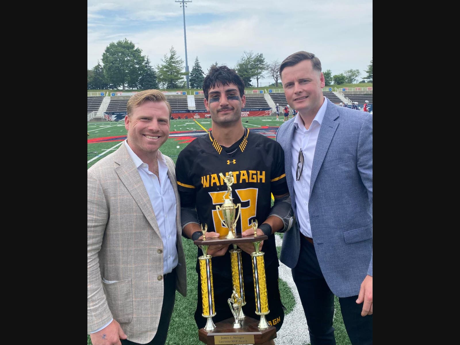 Senior midfielder Joe Nicholson of Wantagh High School received the James C. Metzger MVP Award from Long Island lacrosse all-stars and All-Americans James Pannell and Jack Concorran at the Class C 2026 Long Island Boys Lacrosse Championships.