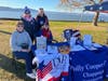Members of the Polly Cooper Chapter man one of the exhibit tables