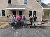 Women Build volunteers prepping to lay cobblestones
