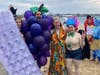 Kennedy Elsey congratulates Costume Contest winners Jenn Brundage of Allston and Christian Matyi  of the South End who splashed as the “Grapes of Raft” and Felicia Harwood of Worcester, who splashed as a stylish troll.