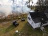 A prescribed fire burns underbrush near a house at the Ordway-Swisher Biological Station in Melrose.
