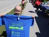 A child holds up his commemorative t-shirt for the Breiter-Palm Park grand opening.