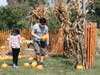Kids receive a free pumpkin at the Harvest Fest pumpkin patch.