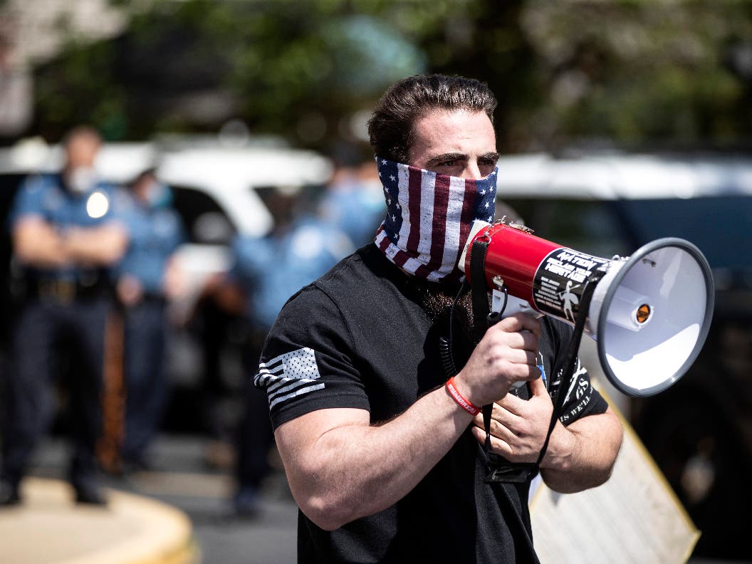 Atilis Gym co-owner Ian Smith speaks with supporters outside his gym in Bellmawr, N.J., on May 19, 2020. 