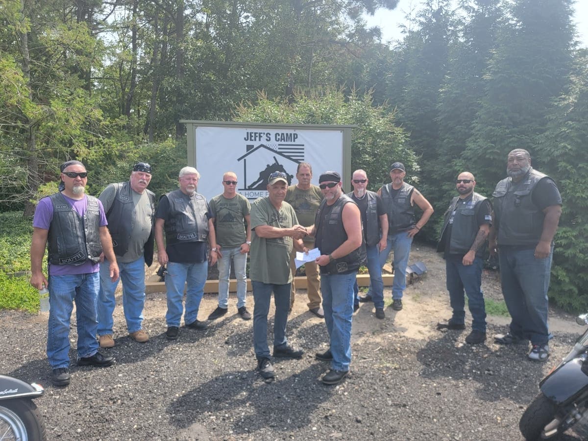 Allegiance South LEMC President Ken Ferm, right, presents a donation on behalf of the club to Jeff's Camp President Martin Weber. 