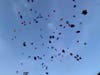 There were heart-shaped and star-shaped balloons, along with some reading "forever in our hearts."