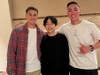 U.S. Marines Corps Sergeants Tyler Rallo (left) and Ryan Cartwright (right), with 1st Battalion, 7th Marines, smile with Reichi Sekiguchi during a dinner at a local restaurant in Kyoto, Japan Feb. 25, 2022. 