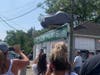 Members of the community eagerly gathered to watch the reveal of the car.