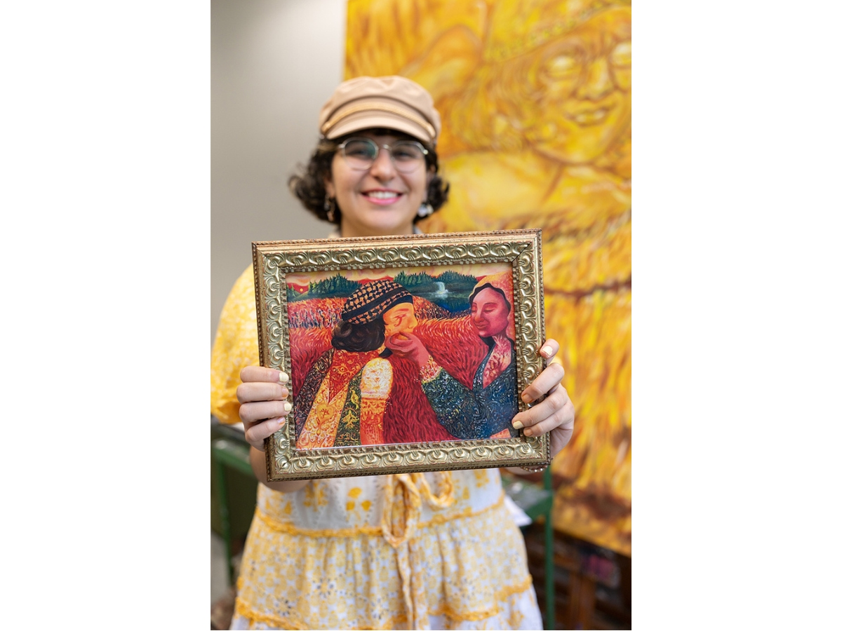 Hanna holds her painting titled ‘Our Lady, Queen of Palestine,’ which she submitted for the AXA Art Prize and is currently on display at the New York Academy of Art.