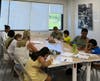 Volunteer mentors work with students on summer reading and math activities.