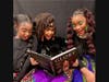Party guests having fun reading a reflective book at a Glory Party.
