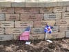 Family and friends leave mementos at their loved ones’ bricks at the site of the American Airlines Flight 191 Memorial Wall and Garden in Lake Park, 1021 Touhy Avenue at Lee Street in Des Plaines, IL.