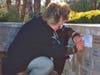 Kim Jockl, daughter of Corrinne and Bill Borchers who were passengers on Flight 191, makes a rubbing of her parents’ bricks at the 40th anniversary Remembrance ceremony.