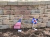 Family and friends leave mementos at their loved ones’ bricks at the site of the American Airlines Flight 191 Memorial Wall and Garden in Lake Park, 1021 Touhy Avenue at Lee Street in Des Plaines, IL.