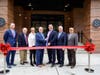 Representatives of Advance Realty and Harrison, NJ municipal officials cut ceremonial ribbon to officially open The Wyldes luxury rental.