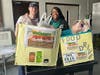 Community Center staff member Jake Sliter helps Ms. Pyeisha deliver the food collection to the Village Pantry.