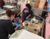 Kennedy School culinary arts teacher Belen Hernandez helps a student measure cocoa for a batch of chocolate cupcakes.
