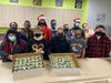 Kennedy School students proudly display some of the cupcakes they made for Atlas Putty Products Co. Students were thrilled when told the company had hired them to make 125 cupcakes for the company’s holiday gathering. 