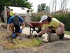 Baird & Warner Realtor Cathy Mead (right) works with her son Zach to clear a garden bed at St. Coletta’s of Illinois.