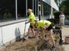 Baird & Warner Realtors Mary Volk (left) and Kim Keller remove weeds and roots from a garden bed at St. Coletta’s of Illinois on June 7.