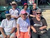 Participants from St. Coletta’s Community Day Services program wait for the Joliet Slammers to take the field on July 19. 