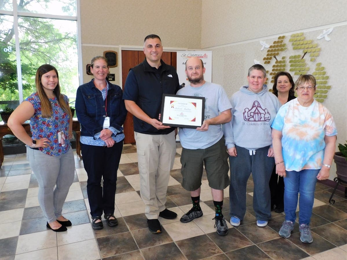 Orland Township Highway Commissioner Antonio Rubino (center) accepts a Friendship Award from participants and administrators at St. Coletta’s of Illinois on Aug. 7. 