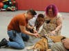 Kennedy School Behavior Specialist Sarah Peirce (far left) shows a student how to pet Kare 9 Nigel during a recent visit.
