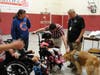 Veteran handler Jim Morrison (far right) introduces Kare 9 Nigel to Kennedy School students on Aug. 9. 