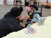 Kennedy School Paraprofessional Diamond Harrison helps a student decorate a pumpkin at St. Coletta’s Fall Fest on Sept. 22.