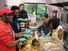 Culinary arts students separate the turkey meat from the bone as they prepare to serve Thanksgiving dinner to nearly 100 classmates, teachers and staff at St. Coletta’s Kennedy School on Nov. 22.

