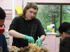 Culinary arts students separate the turkey meat from the bone as they prepare to serve Thanksgiving dinner to nearly 100 classmates, teachers and staff at St. Coletta’s Kennedy School on Nov. 22.