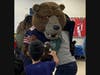 A Kennedy School student gives Staley Da Bear a big bear-hug during his school visit on Jan. 25.