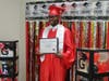 Proud graduate Jakobe M. poses with his diploma, celebrating his achievement at the Lt. Joseph P. Kennedy Jr. School for Exceptional Children on May 22, 2024.