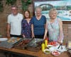 Pastor Don and the dedicated volunteers of All Saints Lutheran Church take a moment to catch their breath after serving up dozens of hot dogs and burgers at a summer picnic.