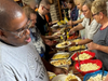 Members of All Saints Lutheran Church serve up hamburgers, hot dogs and homemade side salads to participants of St. Coletta’s of Illinois’ Community Day Services program on June 5.