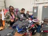 St. Coletta’s Training Specialist/DSP Rakeeta Johnson (left) leads a team of volunteers as they hang clothing for My Joyful Heart in Mokena.