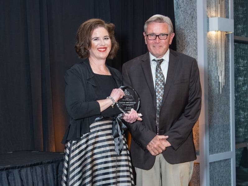 Heather Benedick, CEO of St. Coletta’s of Illinois, presents the organization’s Humanitas Award to Pastor Don Borling from All Saints Lutheran Church in Orland Park. The award is presented annually to individuals who serve as role models in society. 