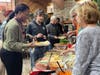 Training Specialist Shaleka Wilkins lends a helping hand as Kevin C., a participant in St. Coletta's Community Day Services program, fills his plate with Thanksgiving favorites.