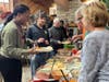 Training Specialist Shaleka Wilkins lends a helping hand as Kevin C., a participant in St. Coletta's Community Day Services program, fills his plate with Thanksgiving favorites.