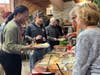 Training Specialist Shaleka Wilkins lends a helping hand as Kevin C., a participant in St. Coletta's Community Day Services program, fills his plate with Thanksgiving favorites.