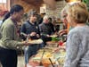 Training Specialist Shaleka Wilkins lends a helping hand as Kevin C., a participant in St. Coletta's Community Day Services program, fills his plate with Thanksgiving favorites.