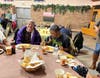 Ronna S. and Farrakhan M. enjoy a Thanksgiving meal together.