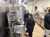 Two Kennedy School students sauté onions to perfection, filling the kitchen with savory aromas as they prepare the stuffing mix for the Thanksgiving feast!