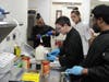 Culinary Arts Supervisor and Instructor Amy Quinn observes with as Kennedy School students carefully measure ingredients for green bean casserole, ensuring each step is done to perfection for the Thanksgiving feast!
