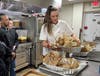 Culinary Arts Supervisor and Instructor Amy Quinn pulls perfectly roasted turkeys from the oven, ready for Kennedy School students to begin removing meat from the bones—a hands-on lesson in kitchen skills!