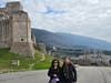 Gigi and Gladys pause for a photo at the 12th-century Rocca Maggiore fortress, overlooking the breathtaking town of Assisi, during their Franciscan pilgrimage.